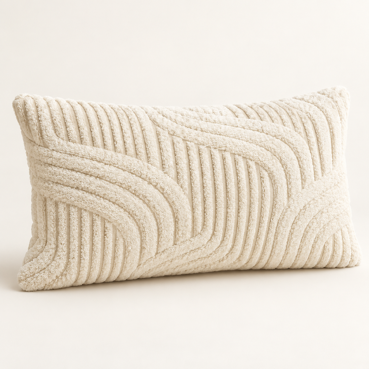 A rectangular lumbar throw pillow in cream with a textured, raised wavy pattern, shown on a neutral light beige background.