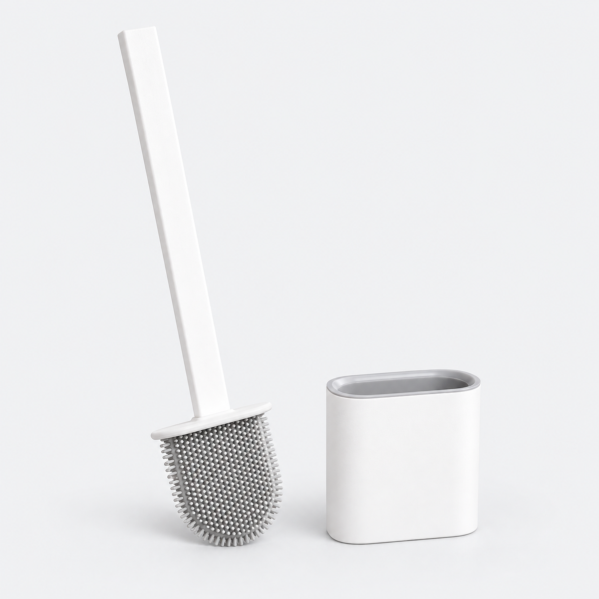A white toilet brush with a gray bristle head standing next to its matching white cylindrical holder on a light gray background.