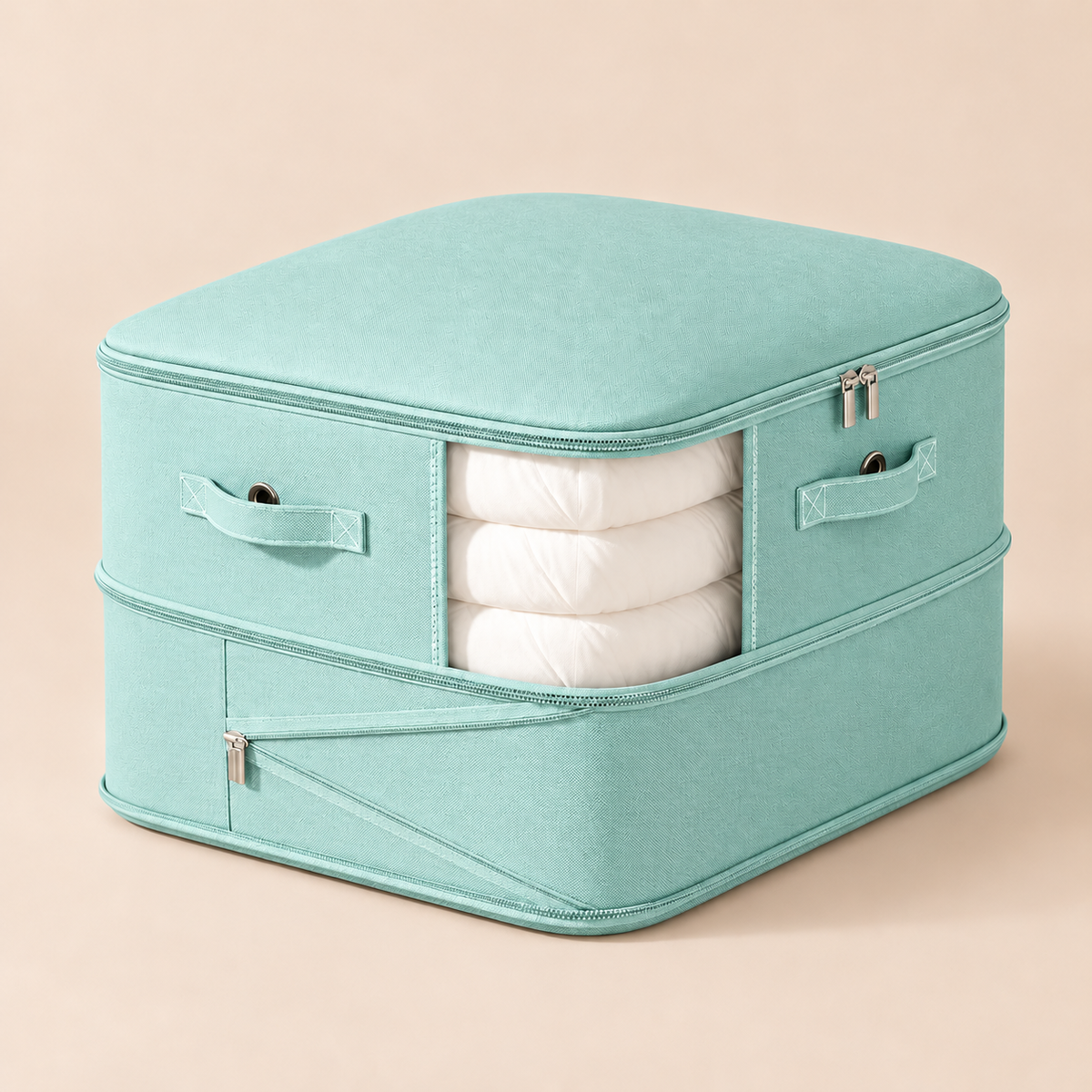 A mint green fabric storage box with a zippered top and side pockets, shown open to reveal folded white bedding or towels inside, set against a solid pale peach background.