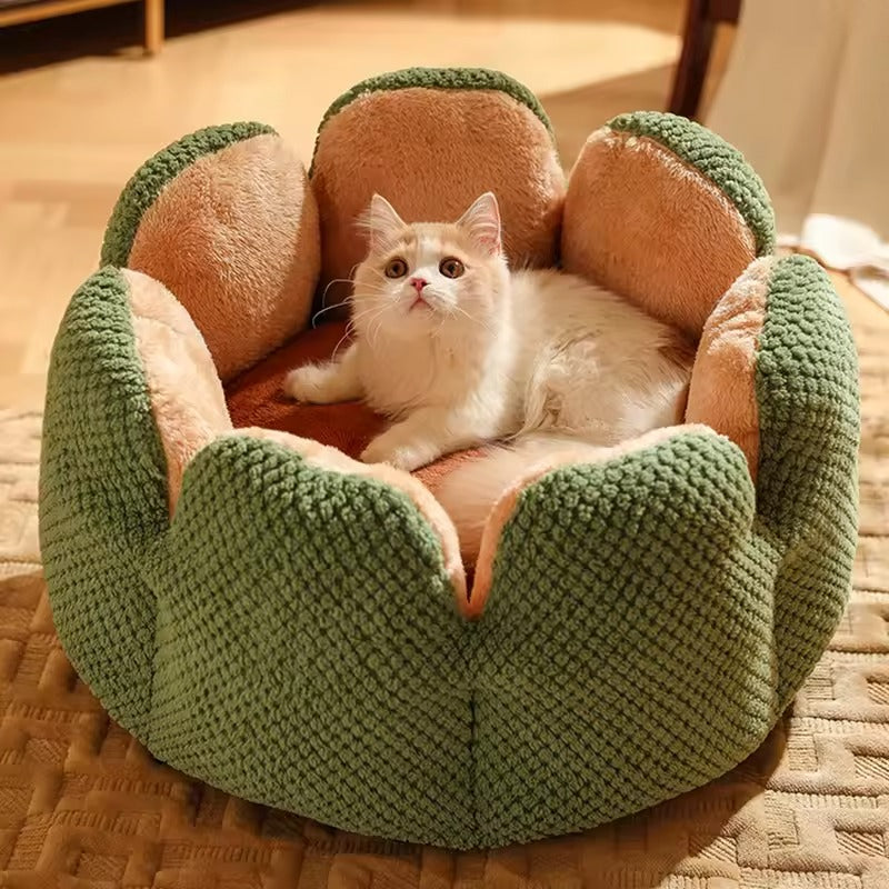 Cozy flower-shaped cat bed made from soft plush fabric, featuring a gentle pink hue. Its 19.7-inch diameter offers a snug retreat for 0