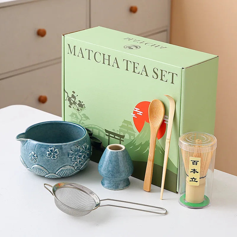 Ceramic matcha bowl set featuring a delicate cherry blossom design, complete with a bamboo whisk. The set showcases soft pink and white hues, perfect for 10