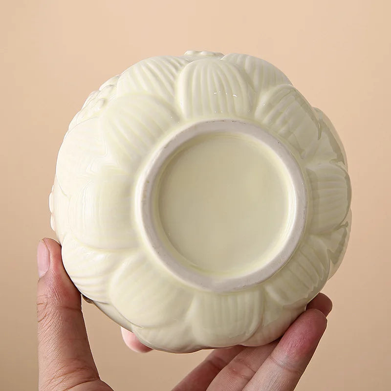 Ceramic matcha bowl set featuring a delicate cherry blossom design, complete with a bamboo whisk. The set showcases soft pink and white hues, perfect for 3