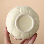 Ceramic matcha bowl set featuring a delicate cherry blossom design, complete with a bamboo whisk. The set showcases soft pink and white hues, perfect for 3