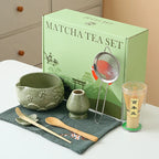 Ceramic matcha bowl set featuring a delicate cherry blossom design, complete with a bamboo whisk. The set showcases soft pink and white hues, perfect for 6