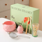Ceramic matcha bowl set featuring a delicate cherry blossom design, complete with a bamboo whisk. The set showcases soft pink and white hues, perfect for 7