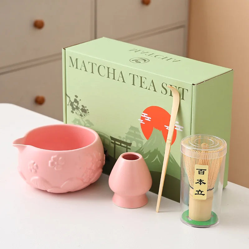 Ceramic matcha bowl set featuring a delicate cherry blossom design, complete with a bamboo whisk. The set showcases soft pink and white hues, perfect for 9