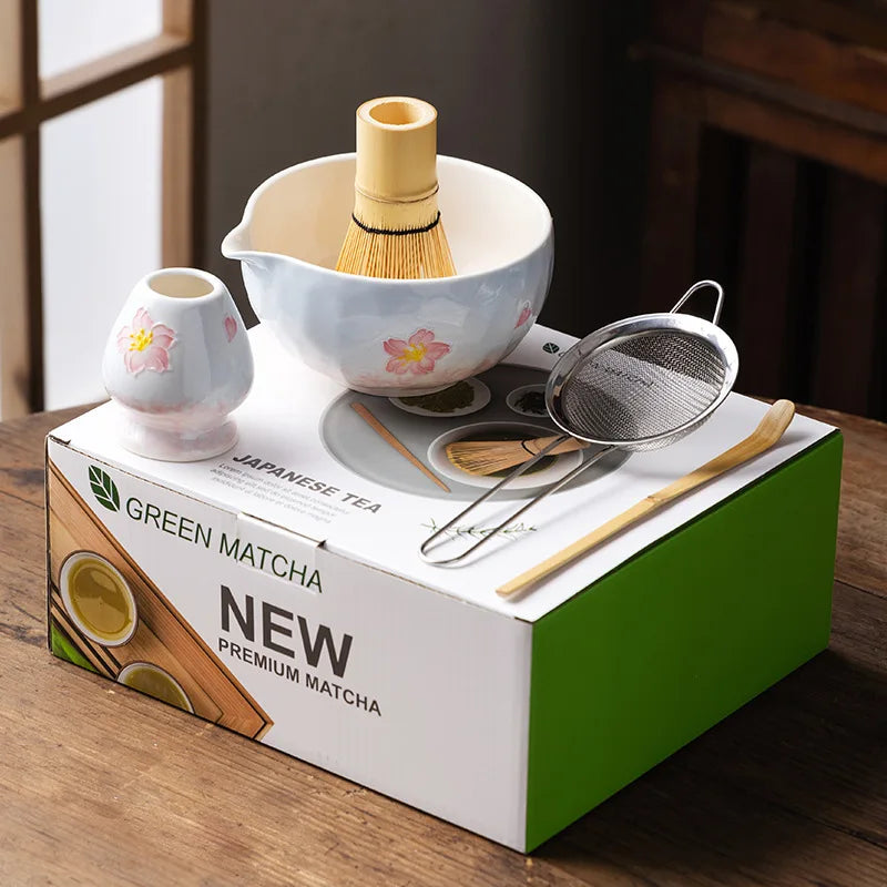 Elegant 5-piece ceramic matcha tea set featuring a delicate cherry blossom design. Includes a matcha bowl, whisk, scoop, and two cups. 3