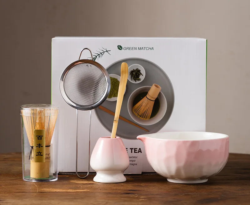 Elegant 5-piece ceramic matcha tea set featuring a delicate cherry blossom design. Includes a matcha bowl, whisk, scoop, and two cups. 4