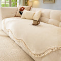Elegant chenille woven sofa cover in a soft cream color, featuring decorative tassels at the edges. This stylish slipcover adds texture and sophistication to your 0