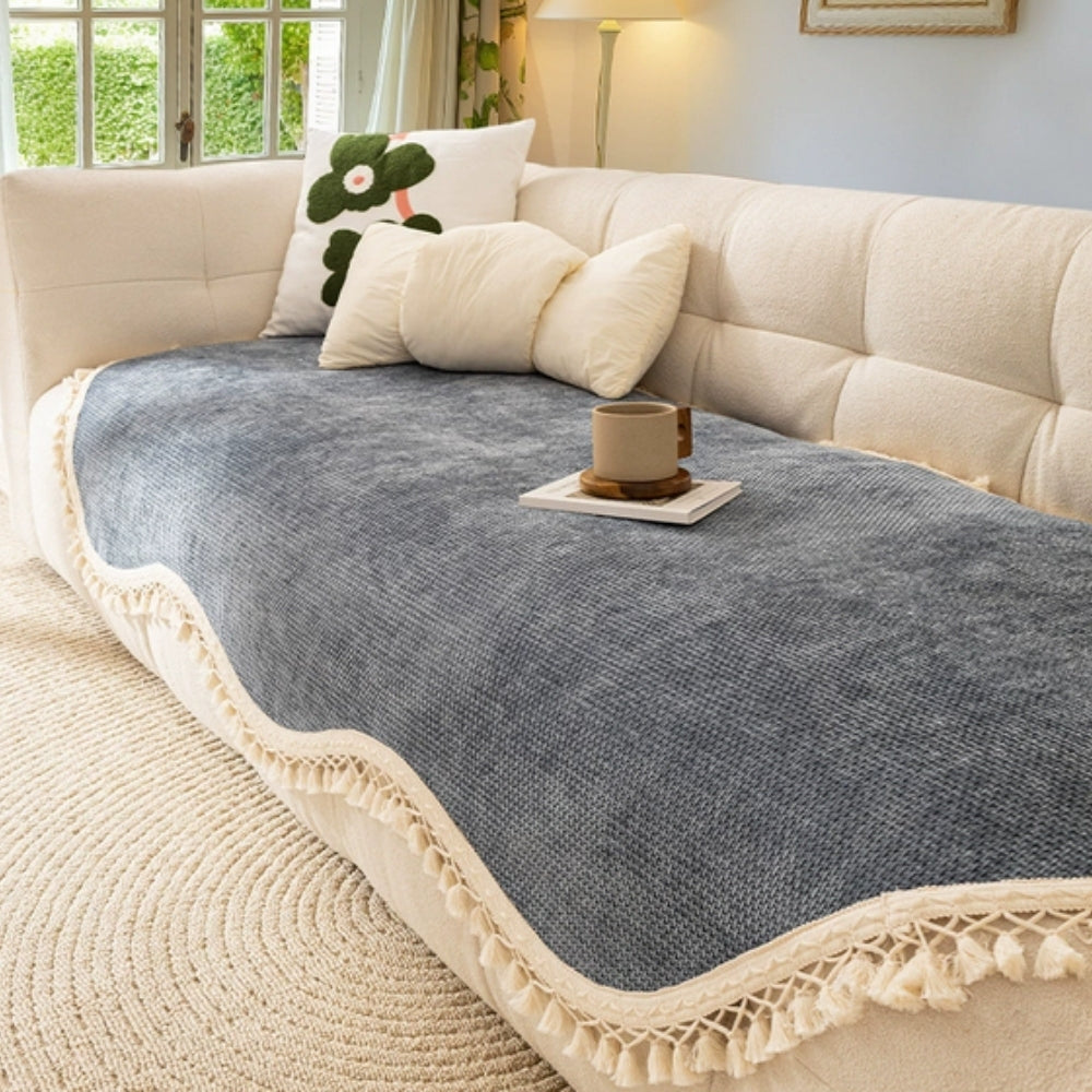Elegant chenille woven sofa cover in soft cream with decorative tassels, designed to protect and enhance your furniture. Ideal for adding a touch of sophistication to 4