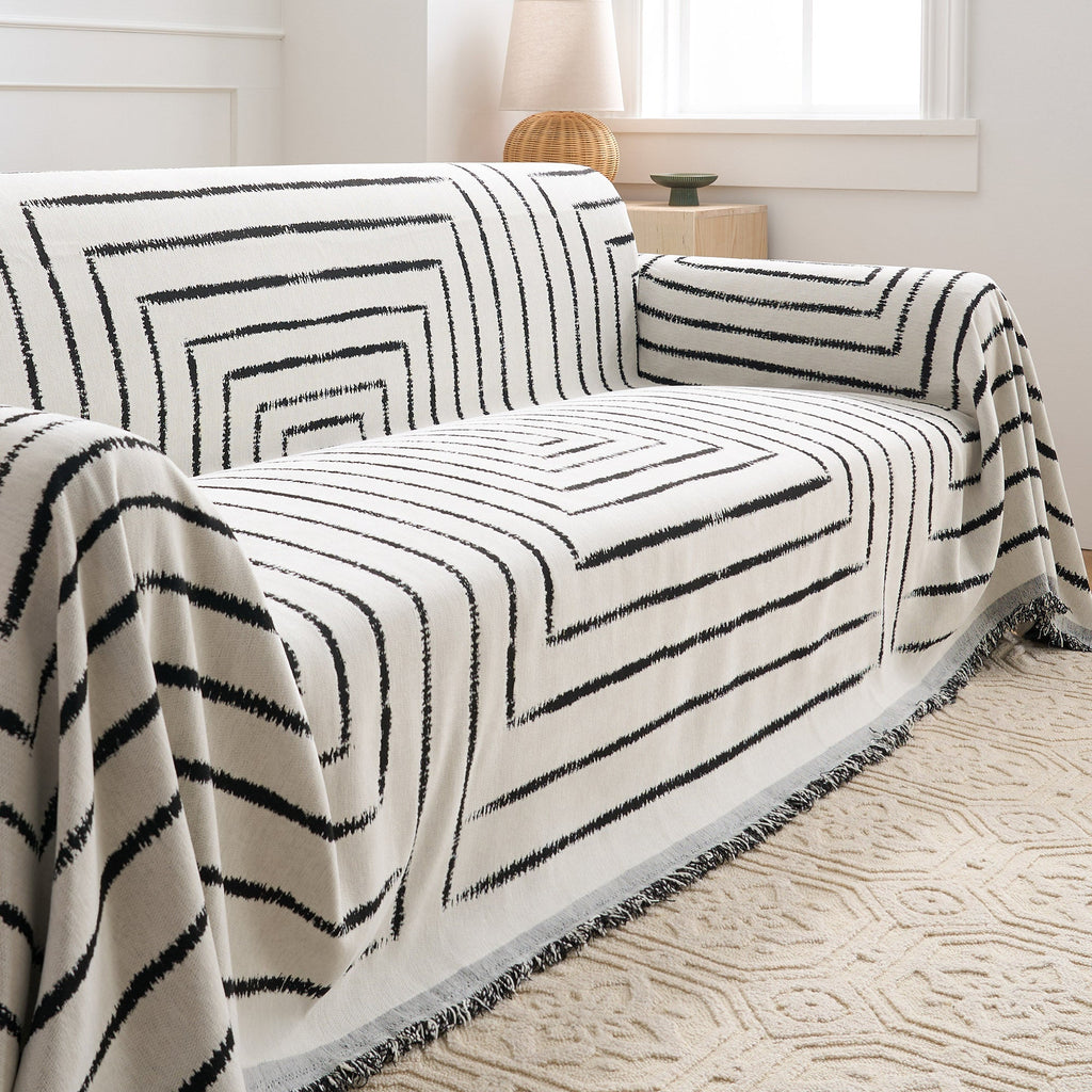 Stylish square pattern sofa cover in soft, pet-friendly fabric. The cover is designed to fit most couches, offering a modern touch while protecting furniture. 3