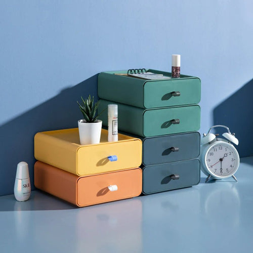 Brightly colored stackable plastic storage boxes designed for home and office organization. Features durable construction, a variety of vibrant hues, and a modular design for 0