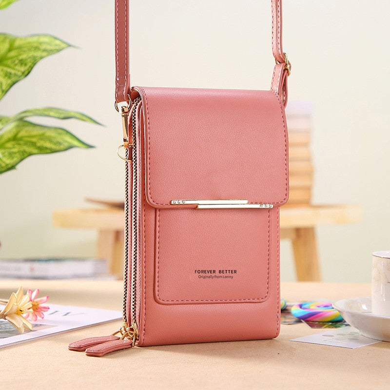 Stylish compact crossbody phone bag in black faux leather, featuring a front card holder and adjustable strap for convenience. Perfect for hands-free use and everyday 5