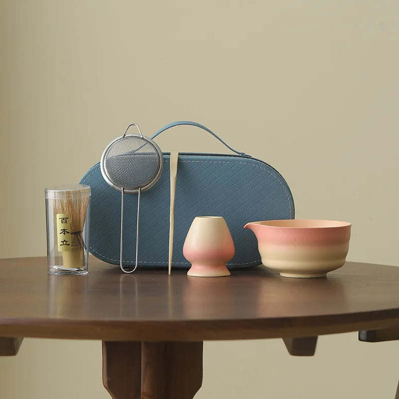 Compact Japanese matcha tea set featuring a stoneware bowl and bamboo whisk, perfect for preparing matcha. The earthy tones of the stoneware enhance the 1