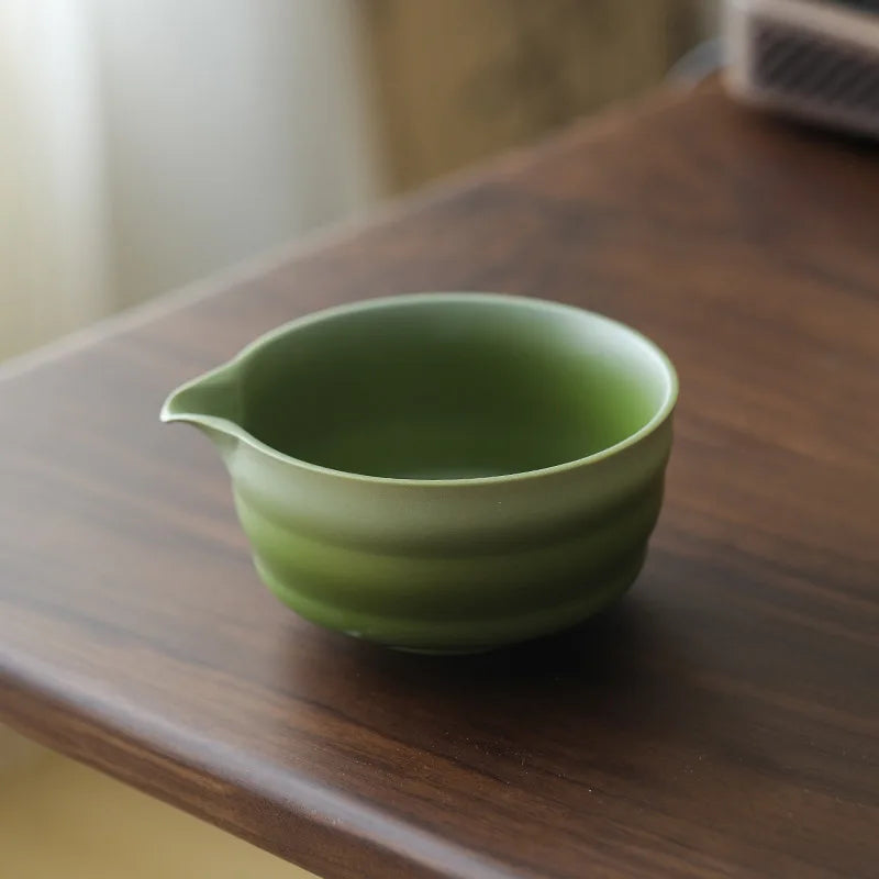 Compact Japanese matcha tea set featuring a stoneware bowl and bamboo whisk, perfect for preparing matcha. The earthy tones of the stoneware enhance the 3