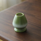 Compact Japanese matcha tea set featuring a stoneware bowl and bamboo whisk, perfect for preparing matcha. The earthy tones of the stoneware enhance the 4