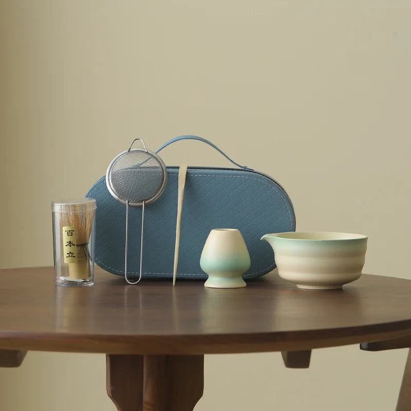 Compact Japanese matcha tea set featuring a stoneware bowl and bamboo whisk, perfect for preparing matcha. The earthy tones of the stoneware enhance the 6