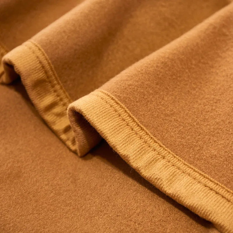 Cozy double-sided velvet blanket in a warm camel color, perfect for all-season use. It features a soft, luxurious texture that adds elegance and warmth 4