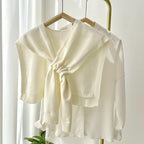 Soft, stylish shawl wrap in a cozy knit design, perfect for all seasons. Features a versatile, lightweight construction in a warm taupe color, 2