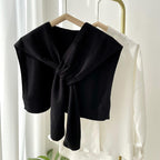 Soft, versatile shawl wrap in a cozy knit fabric, perfect for all seasons. Features a stylish design in a neutral tone, ideal for layering over 9
