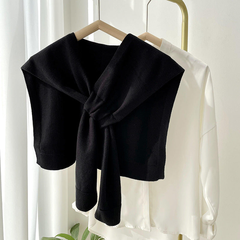 Soft, versatile shawl wrap in a cozy knit fabric, perfect for all seasons. Features a stylish design in a neutral tone, ideal for layering over 9
