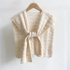 Cozy knitted shawl in warm autumn tones featuring a textured design, perfect for stylish layering. Made from soft, breathable fabric, it adds warmth while 0