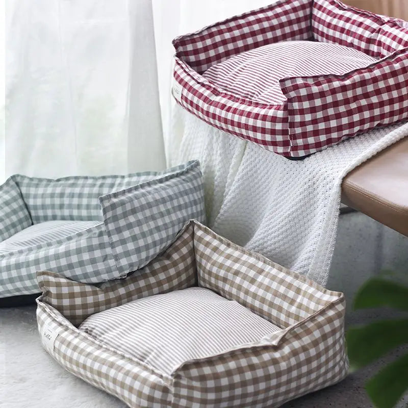 Cozy plaid dog bed designed for small dogs, featuring a soft fabric cushion for comfort. The bed showcases a classic red and black plaid pattern, providing 0