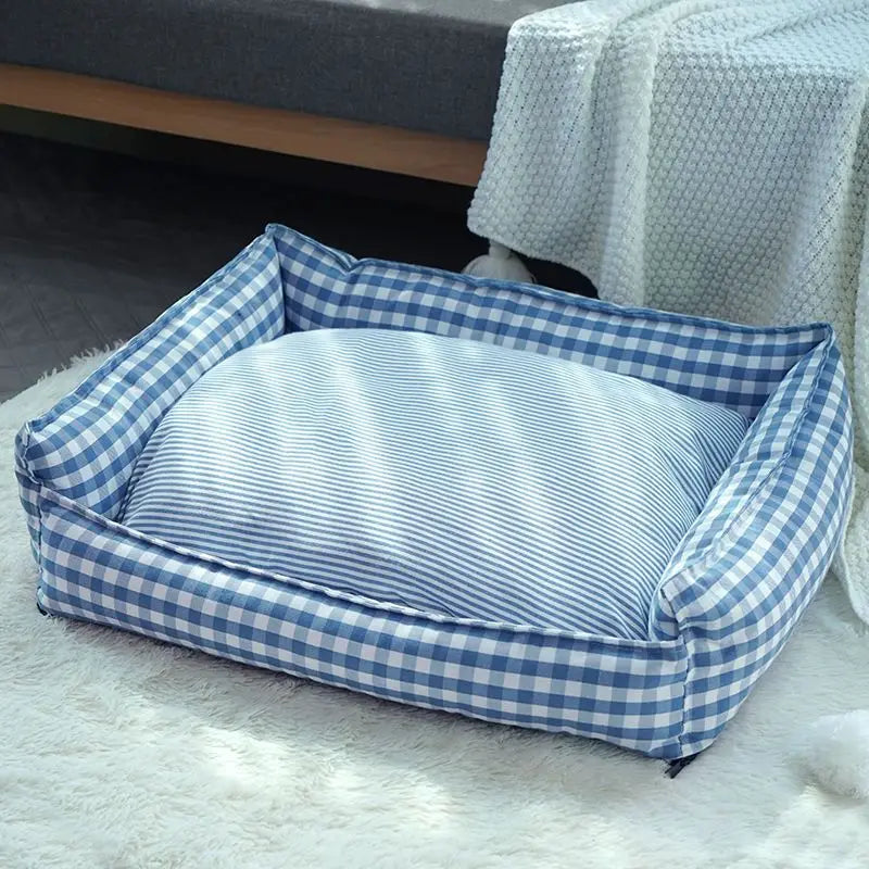 Cozy plaid dog bed designed for small dogs, featuring a soft fabric cushion in warm tones of red, black, and white. The rectangular shape provides 1