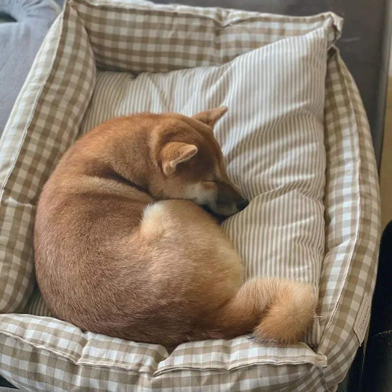Cozy plaid dog bed for small dogs featuring a soft fabric cushion in warm tones of red and beige, designed for comfort and style. Perfect for pam 2