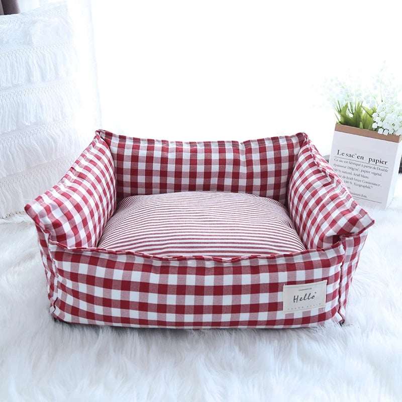 Cozy plaid dog bed designed for small dogs, featuring a soft fabric cushion that provides comfort and support. The bed showcases a classic red and black plaid 7