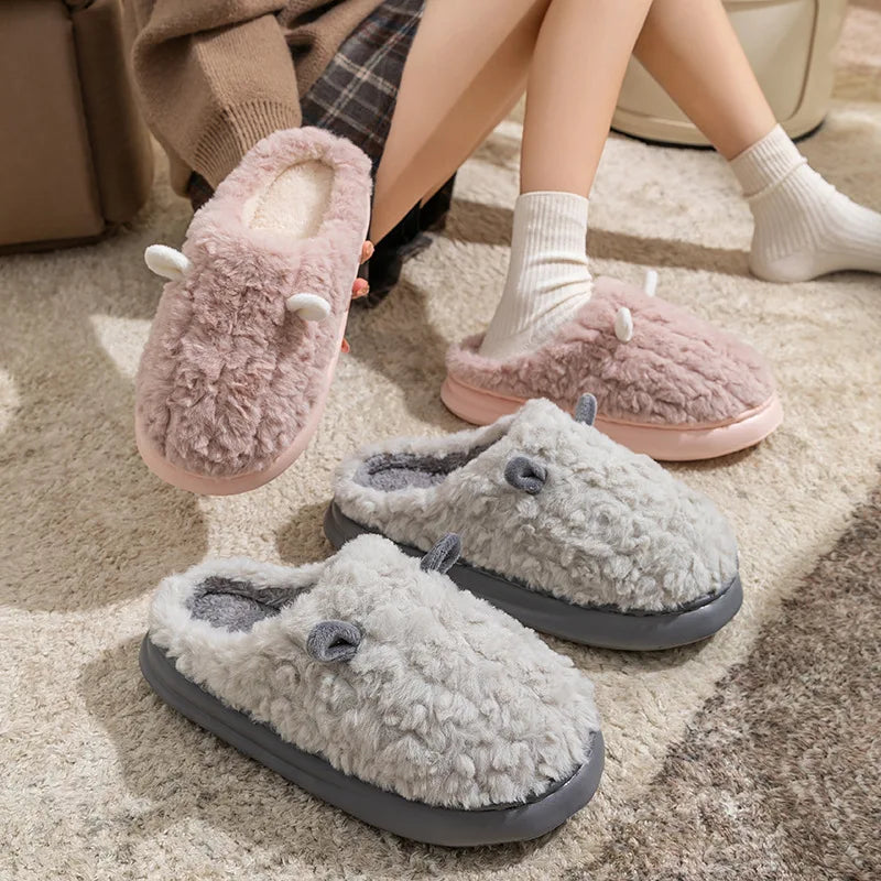 Cozy women's slippers in soft gray cotton, featuring plush fleece lining for warmth and comfort. Ideal for winter, these stylish slip-ons have a textured sole 1