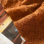 Boho chic crochet curtain in earthy orange, made from a soft microfiber blend. Measures 52 x 84 inches, featuring intricate patterns that add texture 2