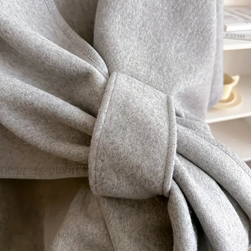Cozy lightweight fleece shawl wrap in a soft gray hue, perfect for stylish comfort. Features a draped design that offers warmth without bulk, ideal 3