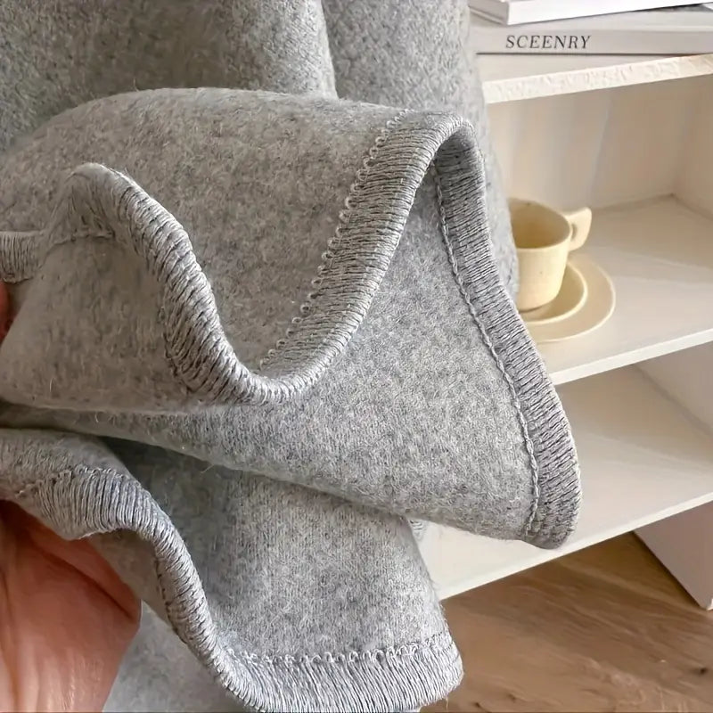 Lightweight fleece shawl wrap in soft gray, featuring a cozy drape for stylish comfort. Perfect for layering, this versatile accessory adds warmth and elegance 4