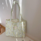 Colorful floral quilted tote bag made from durable cotton, ideal for summer outings. Features sturdy handles and spacious interior, perfect for beach essentials or everyday 5
