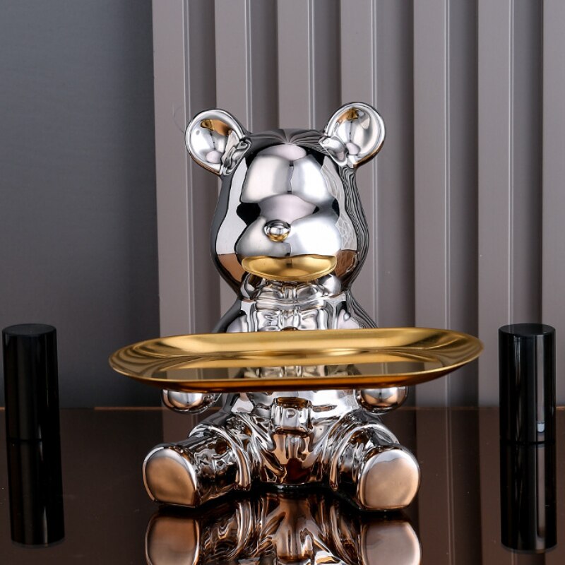 Adorable galvanized piggy bank featuring a bear doll shelf, perfect for saving coins. The shiny silver finish adds a playful touch to any room, making 12