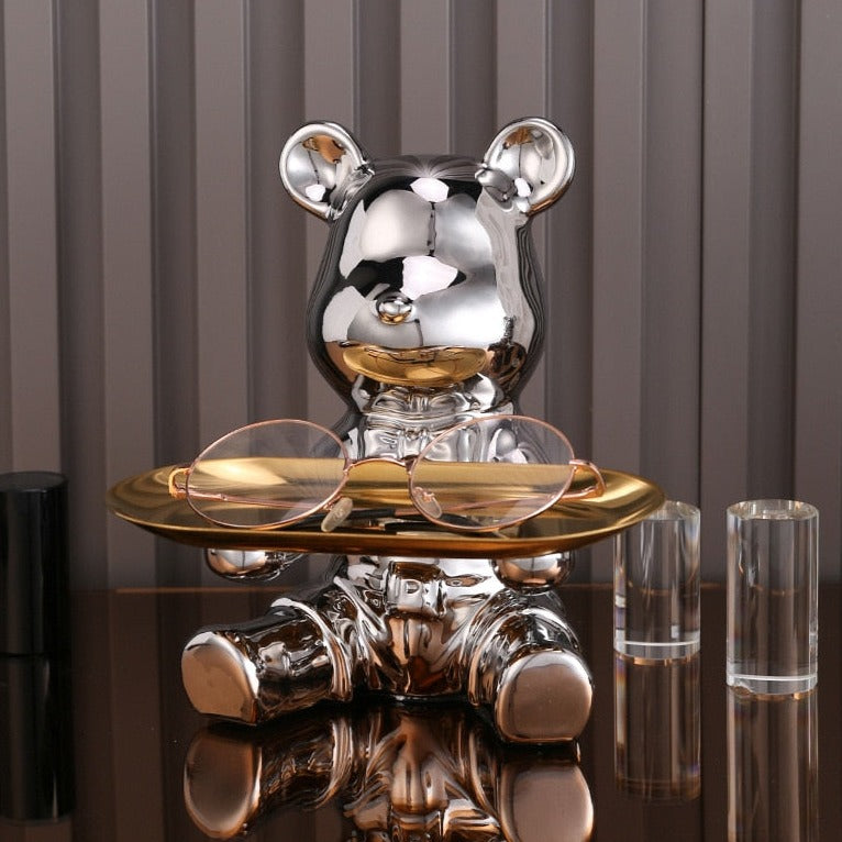 Adorable galvanized piggy bank featuring a bear doll shelf, perfect for saving coins. The shiny silver finish adds a playful touch to any room, making 3