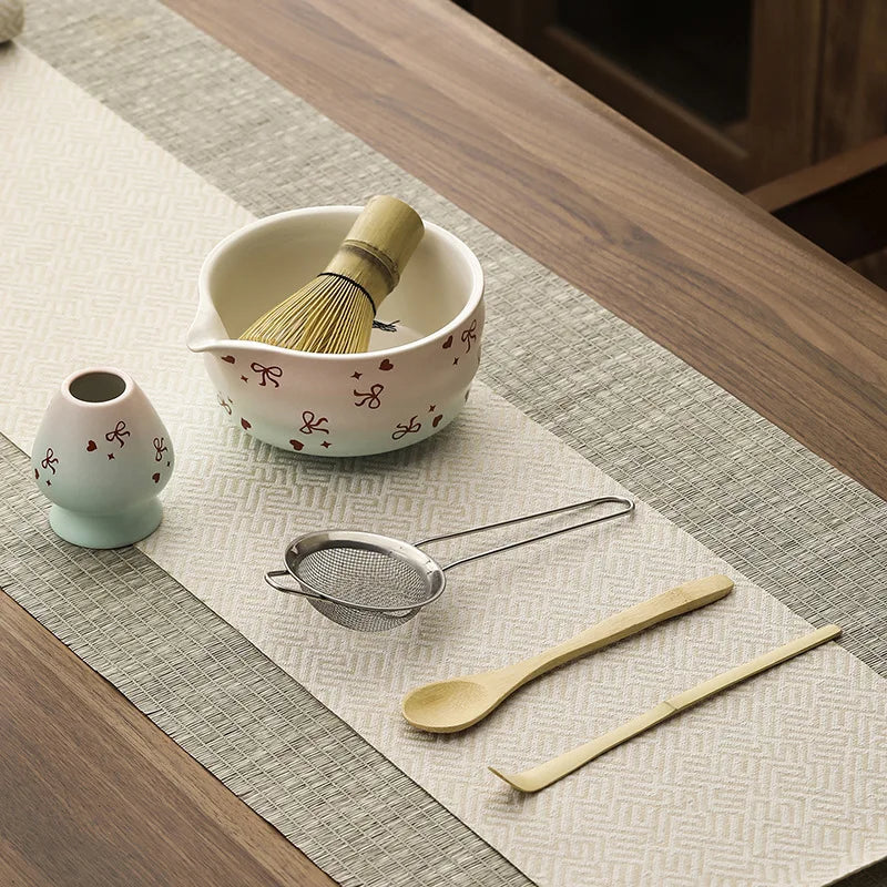 Hand-painted matcha tea set featuring a beautifully crafted bowl and whisk. The set showcases an elegant aesthetic with delicate floral designs in soft green and cream colors 1