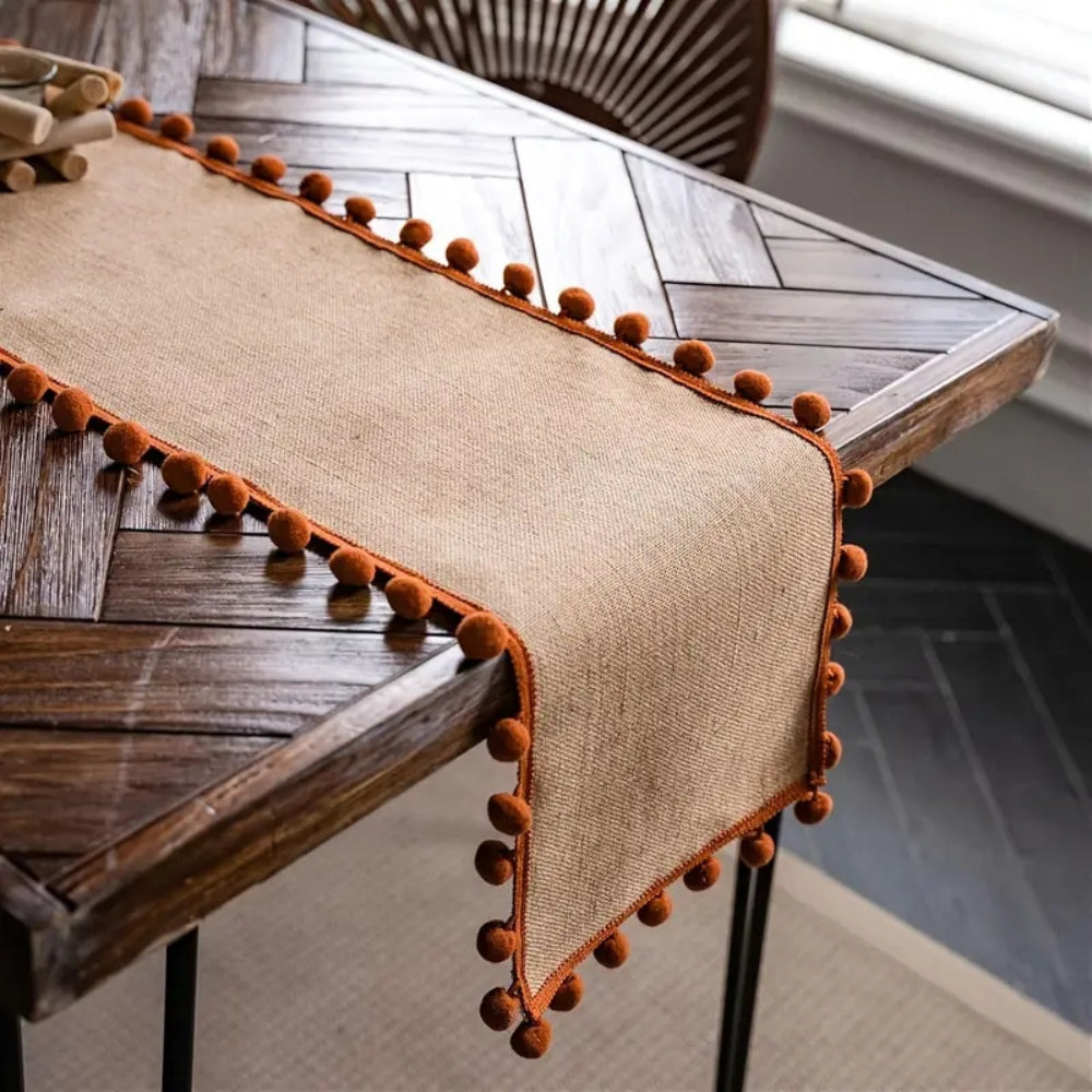 Jute table runner – Durable material – Vibrant orange pom-poms – Bohemian style for dining or living room décor 1