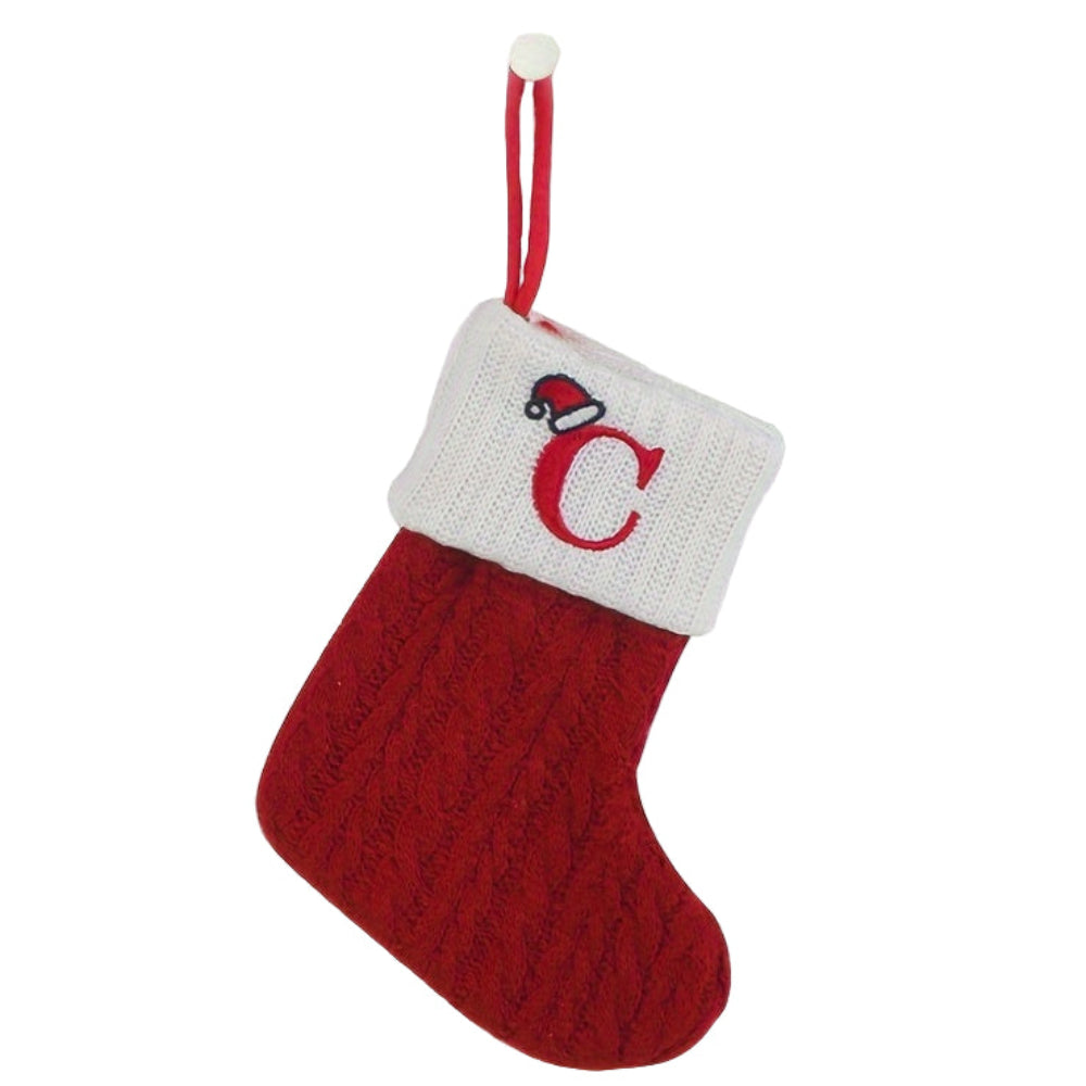 Knit monogram personalized Christmas stocking in festive red with white lettering. Classic knit texture adds warmth, perfect for holiday decor. Ideal for hanging by the 2