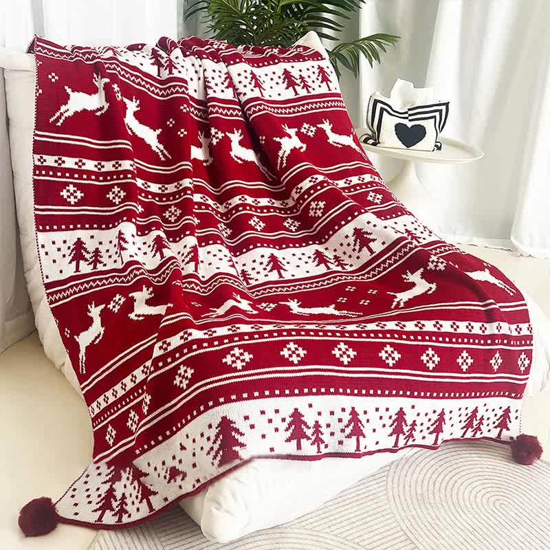 Cozy knitted throw blanket featuring a festive Christmas elk and snowflake design in red and white. Perfect for adding warmth and holiday cheer to your living space 0