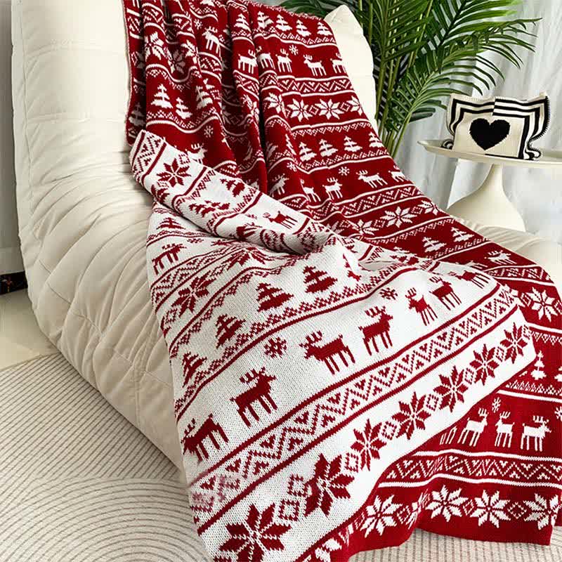 Cozy knitted throw blanket featuring a festive Christmas elk and snowflake design in red and white. Perfect for adding warmth and holiday cheer to your living space 2