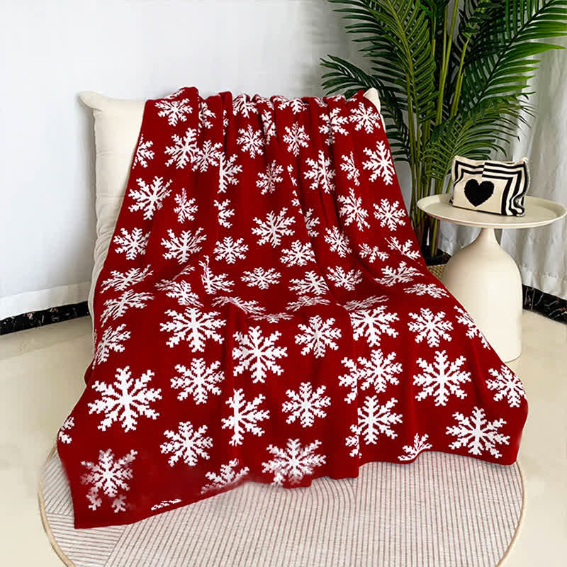 Cozy knitted throw blanket featuring a festive Christmas elk and snowflake design in red and white. Perfect for adding warmth and holiday cheer to your living space 3