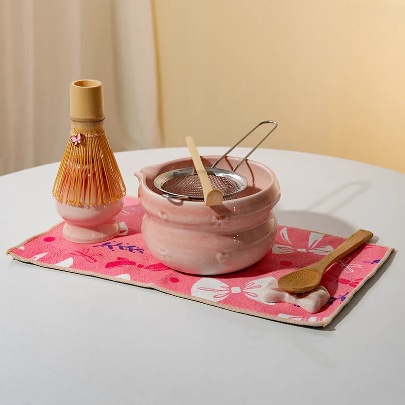 Elegant 7-piece matcha set featuring a beautifully crafted ceramic bowl and whisk, adorned with delicate cherry blossom designs. The set includes a bowl, whisk 2