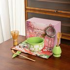 Elegant 8-piece matcha tea set featuring a delicate cherry blossom bowl. Includes a matcha whisk, scoop, and sifter, all crafted from 7