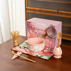 Elegant 8-piece matcha tea set featuring a delicate cherry blossom bowl. Includes a matcha whisk, scoop, and sifter, all crafted from 8