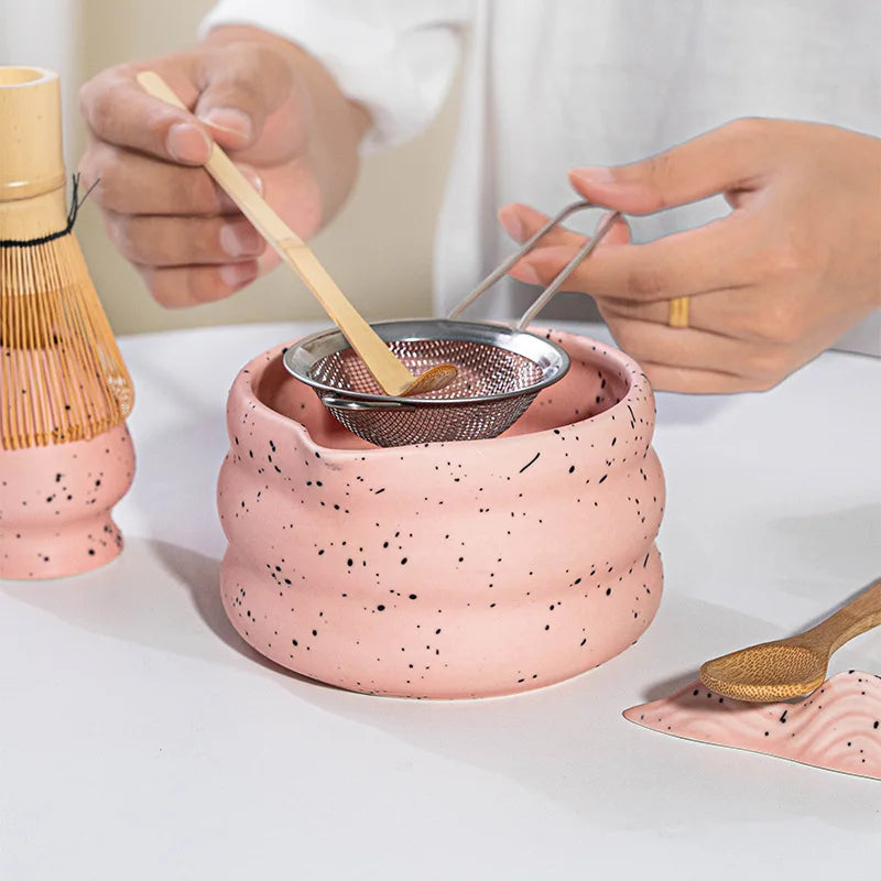 Elegant matcha tea set featuring a handmade ceramic bowl in a soft green hue, accompanied by a traditional bamboo whisk, perfect for tea enthusiasts and makes a 3