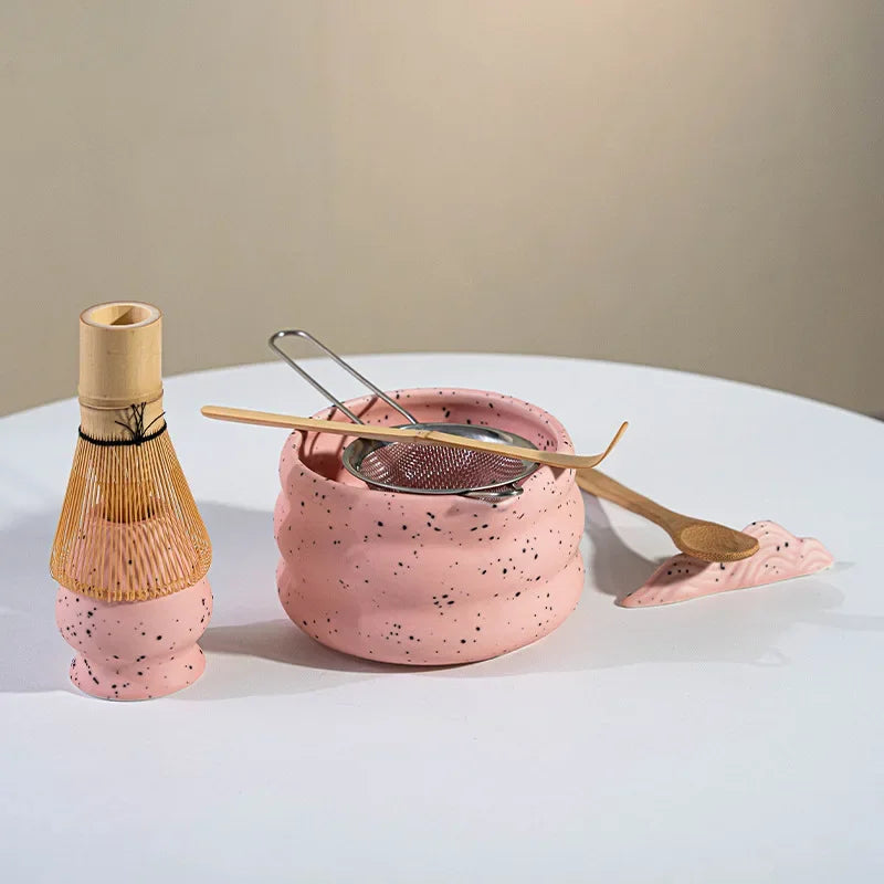 Elegant matcha tea set featuring a handmade ceramic bowl in a soft green hue, accompanied by a traditional bamboo whisk, perfect for tea enthusiasts and makes a 4