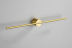 Gold wall-mounted light fixture on a pink background