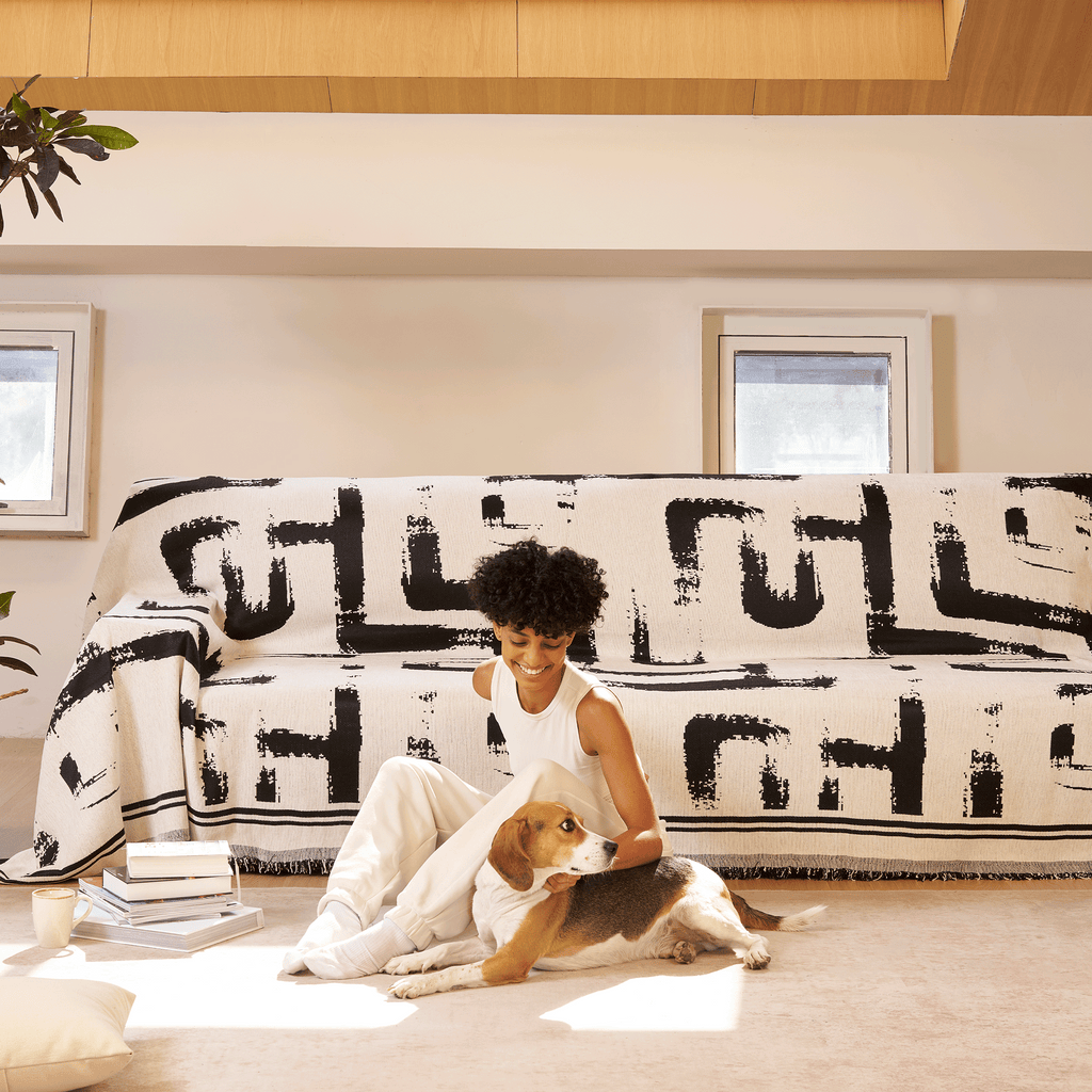 Soft monochrome sofa cover made from breathable, pet-friendly fabric. Designed to protect and enhance your couch, it features a sleek, modern look that fits 2